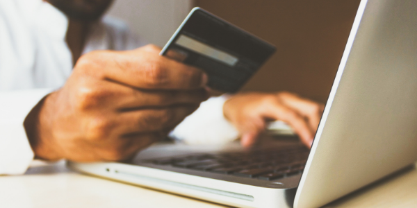 Man entering credit card information on laptop