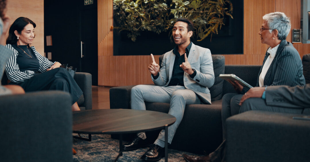 Group, business and meeting with people in lobby for discussion, planning and briefing at convention. Staff, talking and feedback of conference, corporate travel and chat for B2B negotiation at hotel