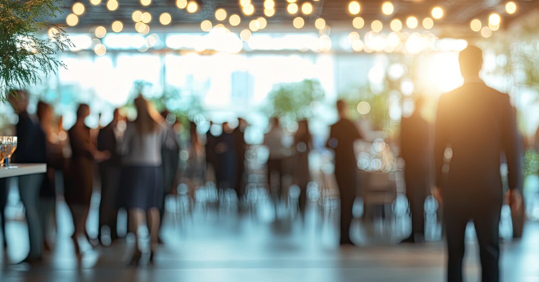 Blurred background of party with lights. Great for background or overlay in a presentation or website to show a busy social gathering.