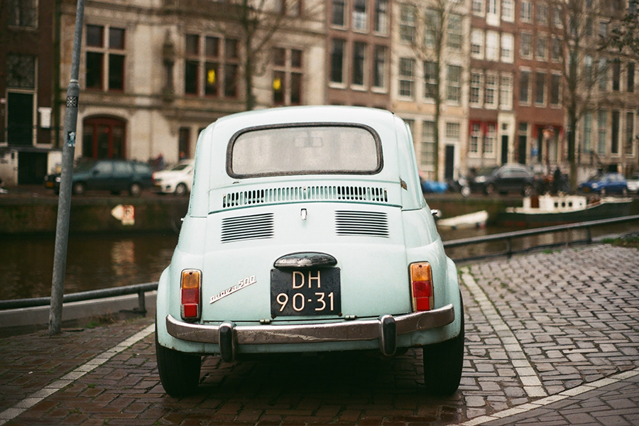 light blue classic car parked on an Amsterdam street