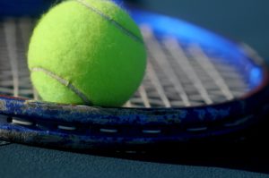 close up of tennis ball on a racquet