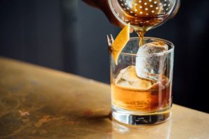 pouring a whisky cocktail