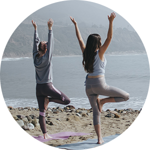 yoga tree pose on the beach