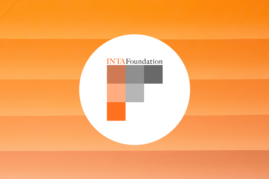 INTA Foundation on orange ombre stripe background