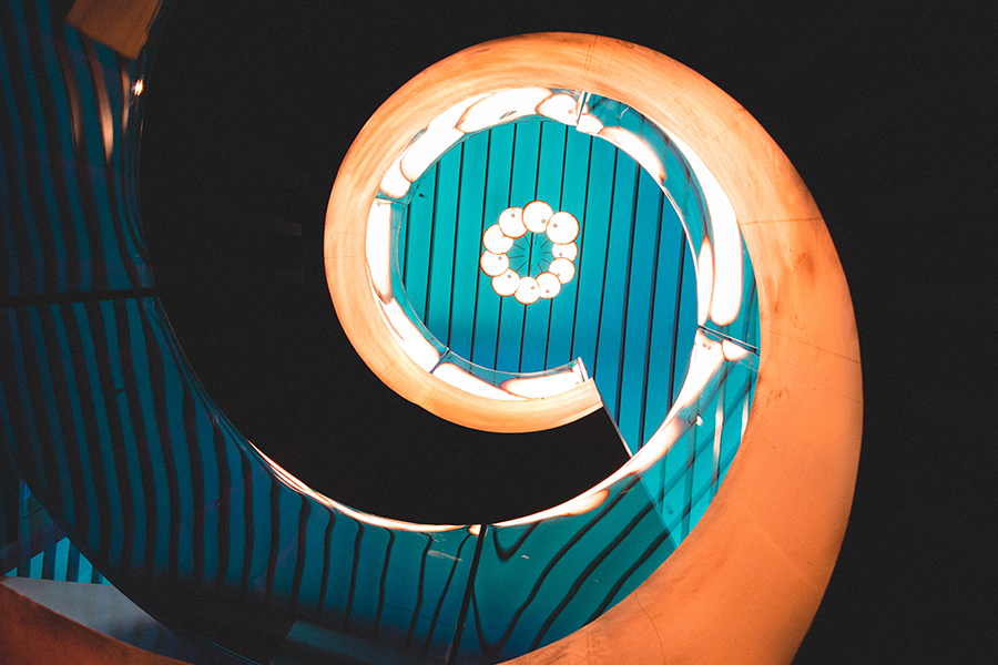 view up through spiral staircase looking at light