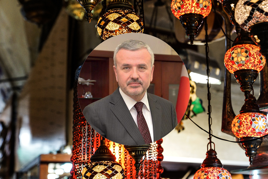 Habip Asan over stained glass lamps in background