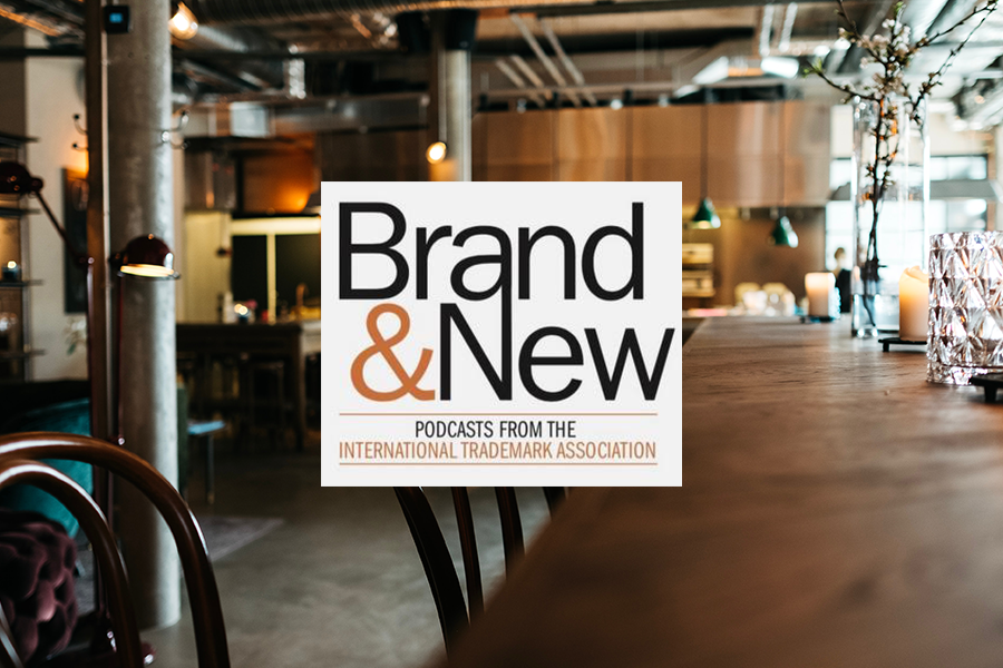 Brand & New podcast logo over a small coffee shop background
