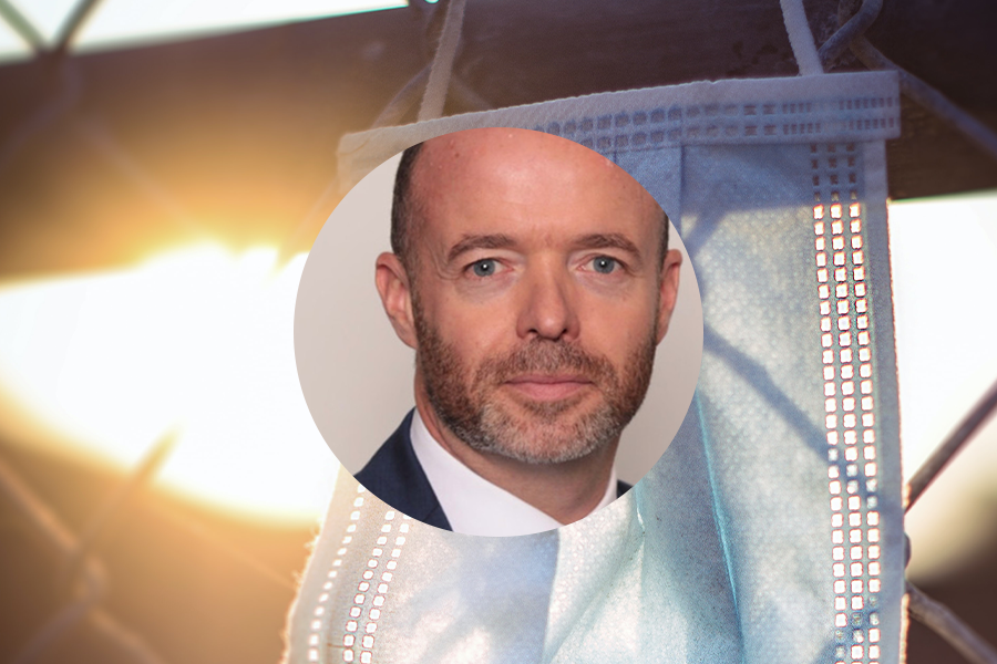 Peter McAleese headshot with out of focus light streaming through disposable face mask