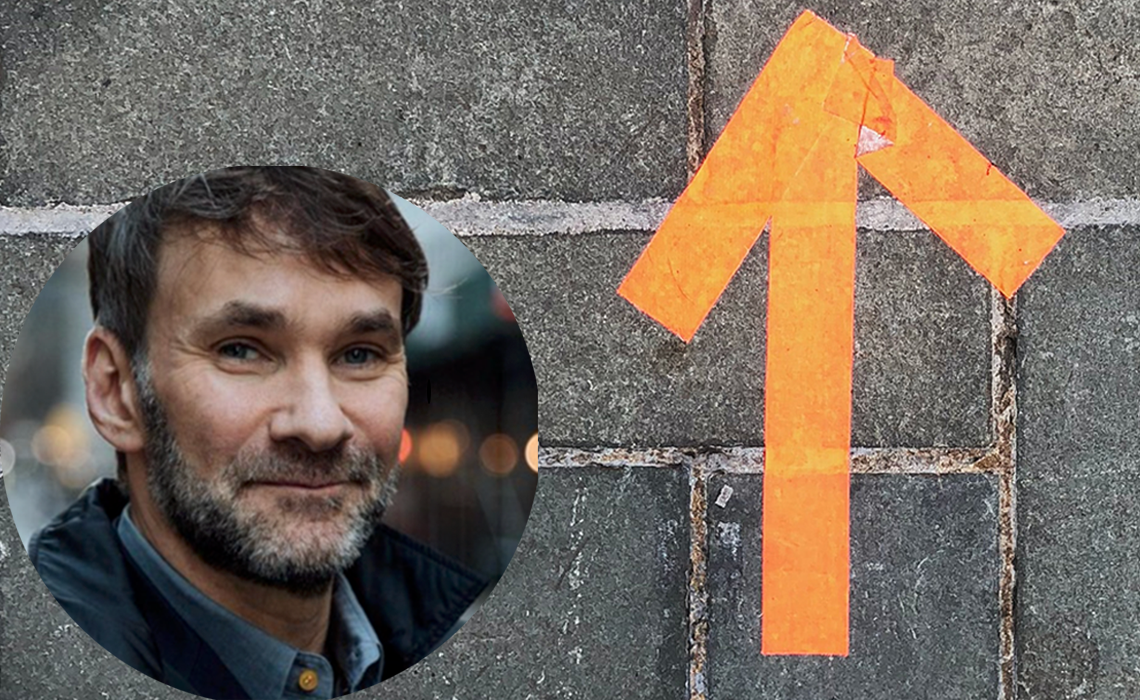 Keith Ferrazzi headshot and orange arrow on paved stones