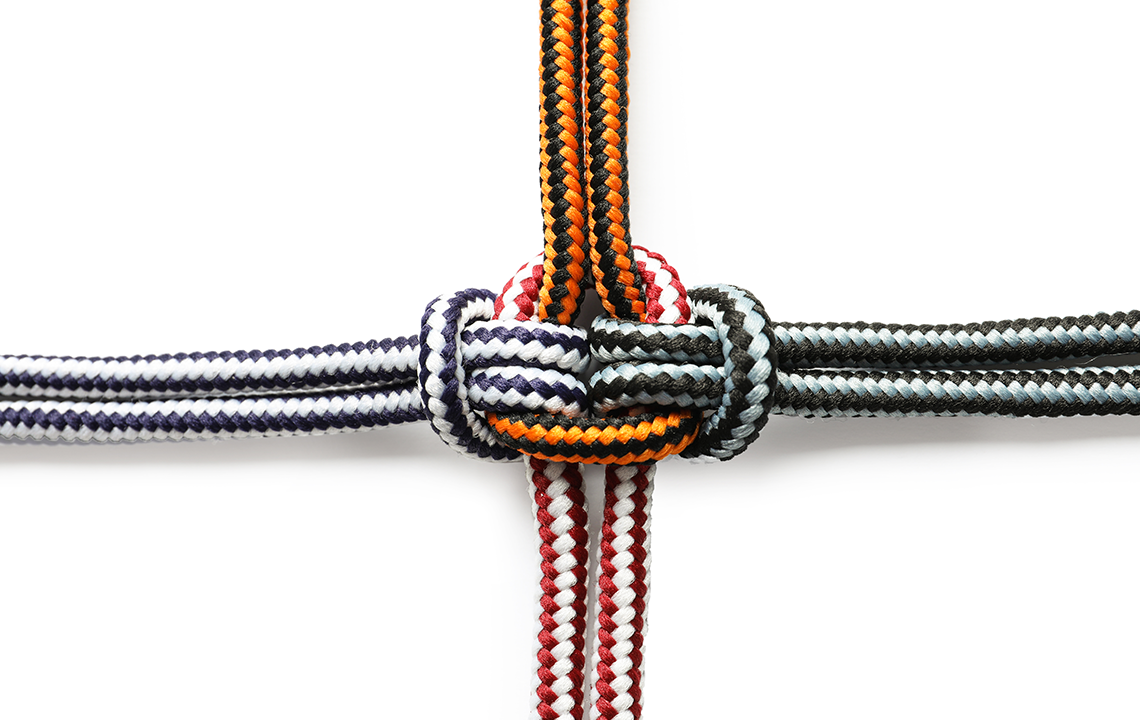 colorful ropes tied together on white background
