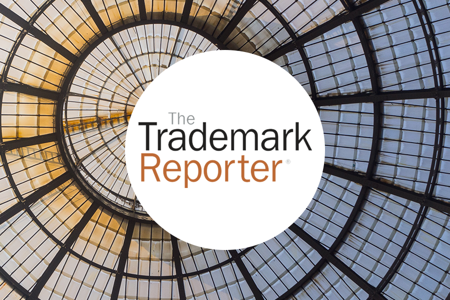 Trademark reporter logo with an aerial glass ceiling view